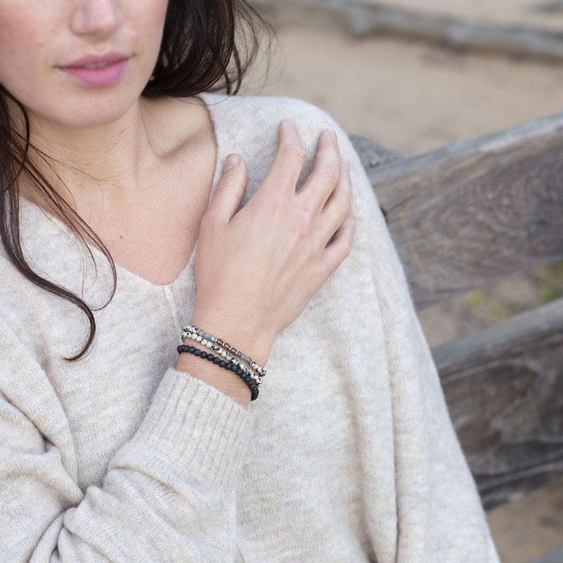 Woman wearing dainty Dalmatian Jasper Delicate bracelet set