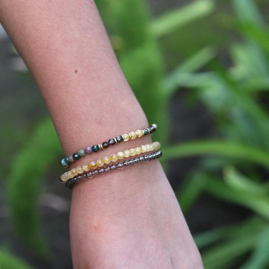Woman wearing dainty Jasper and Citrine bracelet set