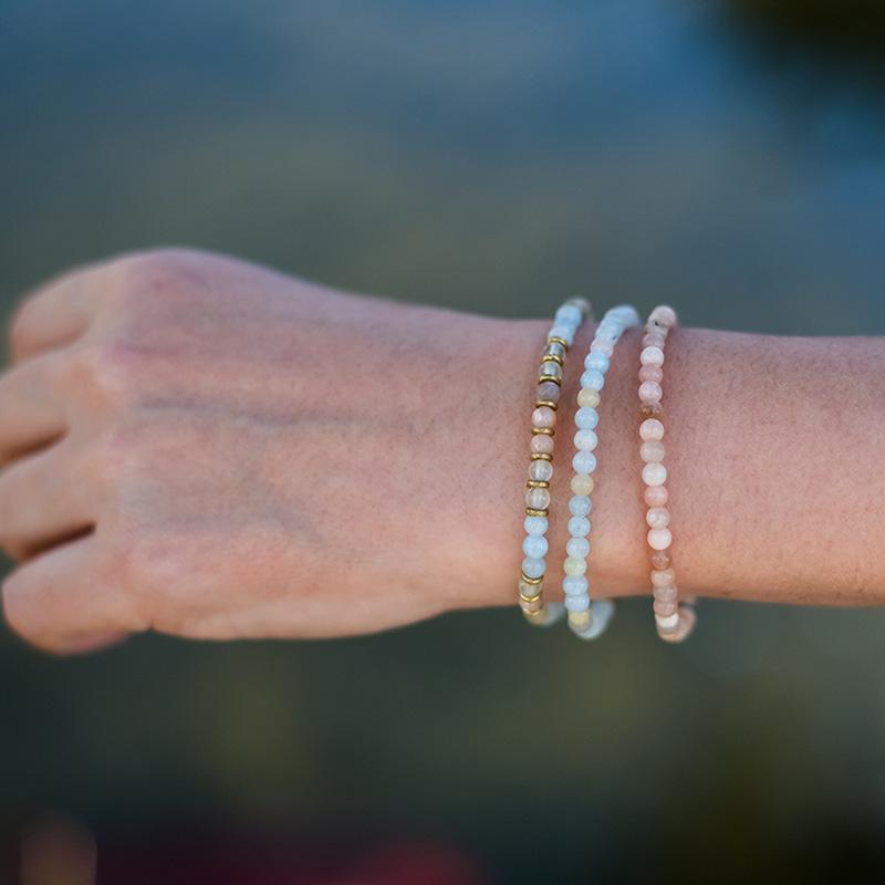 Woman wearing dainty Aquamarine Sunstone and Prehnite bracelet