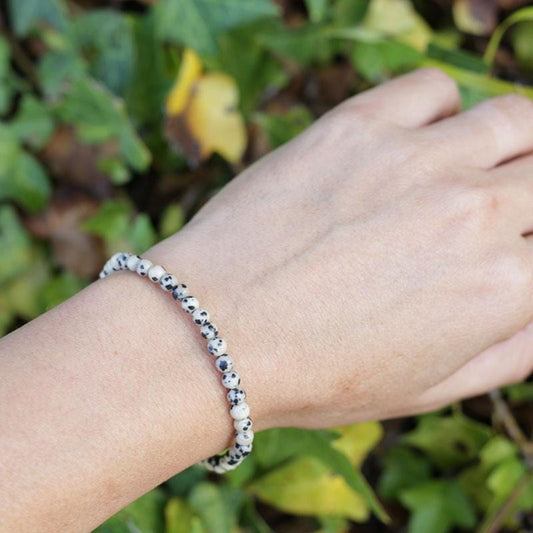 Woman wearing dainty Dalmatian Jasper bracelet