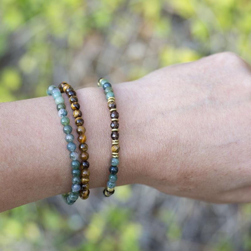 Woman wearing dainty Moss Agate, Smoky Quartz and Tigers Eye bracelet set